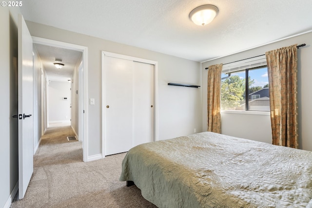 461 NE 16th Ave, Hillsboro, OR 97124 - bedroom featuring carpet flooring, a closet, a textured ceiling, and baseboards