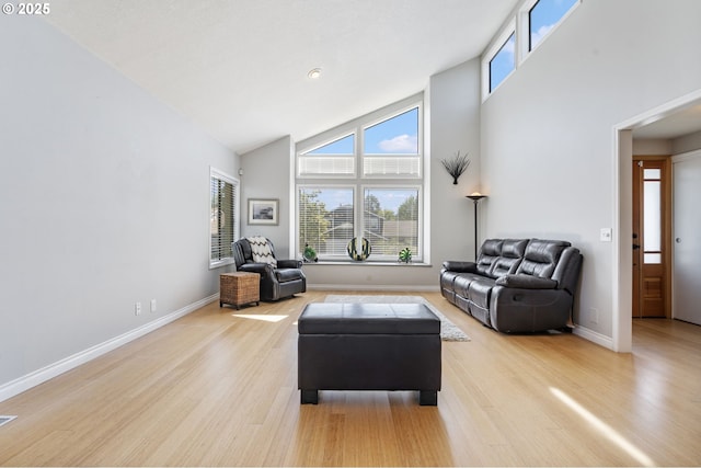 461 NE 16th Ave, Hillsboro, OR 97124 - living room featuring light wood finished floors, healthy amount of natural light, high vaulted ceiling, and baseboards