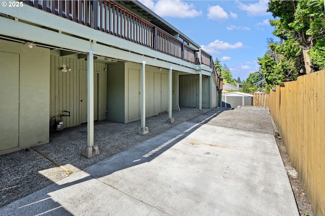 461 NE 16th Ave, Hillsboro, OR 97124 - view of parking with a storage unit and a fenced backyard