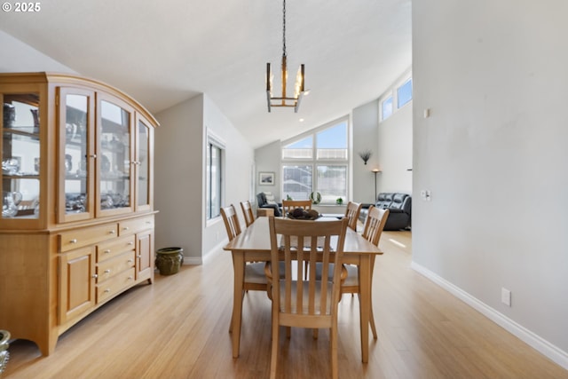 461 NE 16th Ave, Hillsboro, OR 97124 - dining room featuring light wood-style flooring, baseboards, lofted ceiling, and a chandelier