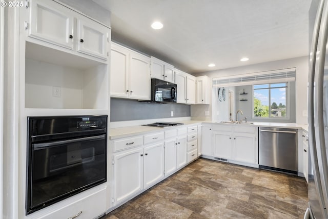 461 NE 16th Ave, Hillsboro, OR 97124 - kitchen with black appliances, a sink, white cabinets, stone finish floors, and recessed lighting
