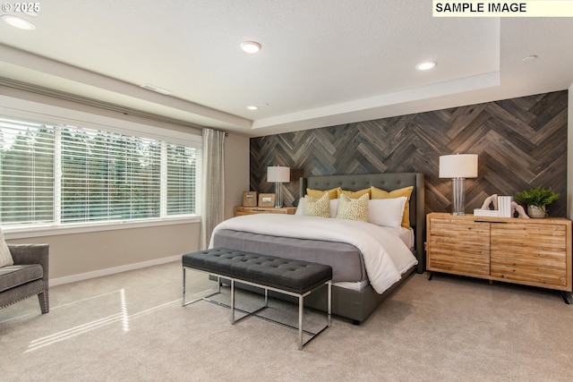 carpeted bedroom featuring visible vents, an accent wall, baseboards, and recessed lighting