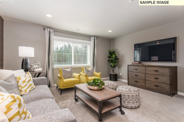 living room with recessed lighting, visible vents, baseboards, and light colored carpet