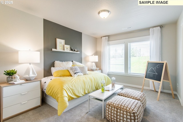 bedroom with visible vents, light carpet, and baseboards