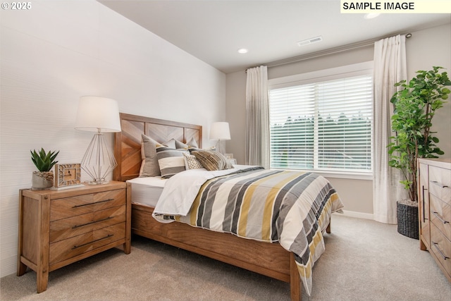 bedroom featuring baseboards, visible vents, and light colored carpet