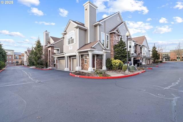 view of building exterior featuring a residential view and a garage