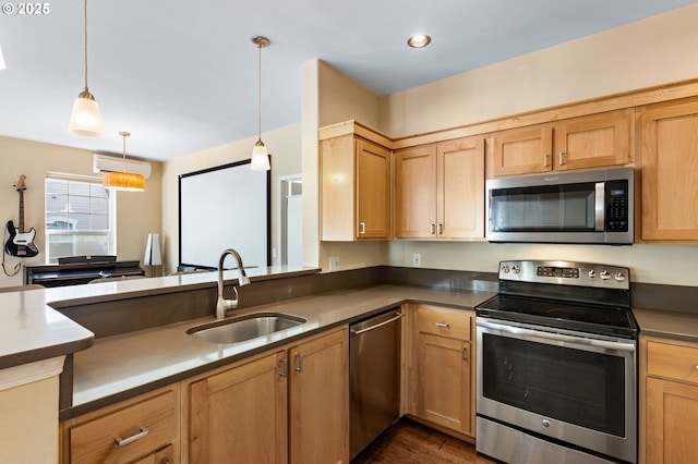 kitchen with hanging light fixtures, appliances with stainless steel finishes, a sink, a wall mounted air conditioner, and dark wood-style floors
