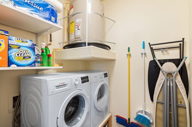 laundry area with laundry area, independent washer and dryer, and secured water heater