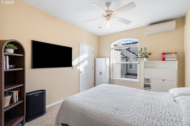 bedroom with carpet flooring, a ceiling fan, baseboards, and a wall mounted AC