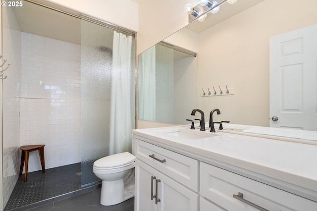 full bath with vanity, tile patterned floors, toilet, and a tile shower