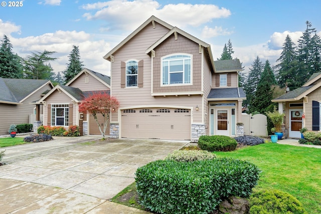 craftsman inspired home featuring a front yard and a garage