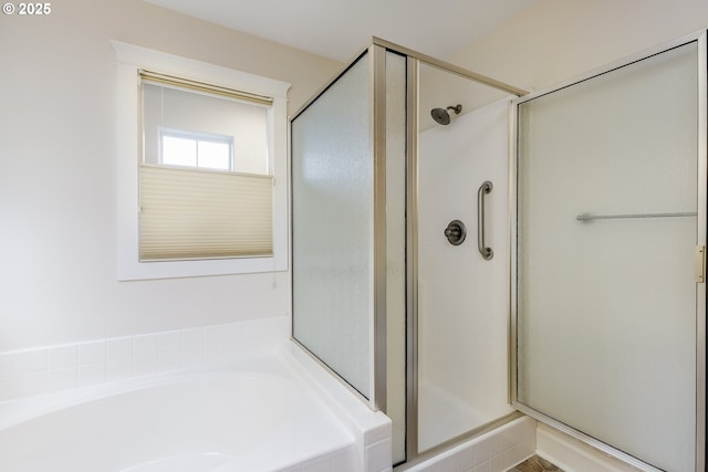 bathroom featuring separate shower and tub