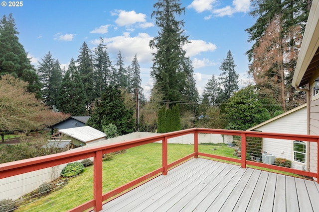 wooden terrace featuring a yard and central AC