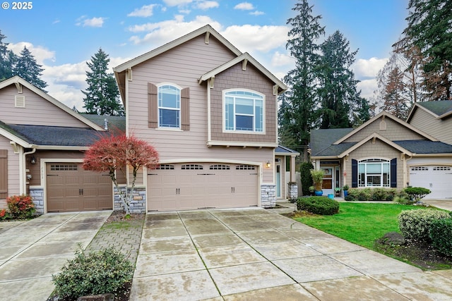 craftsman-style home featuring a garage and a front lawn