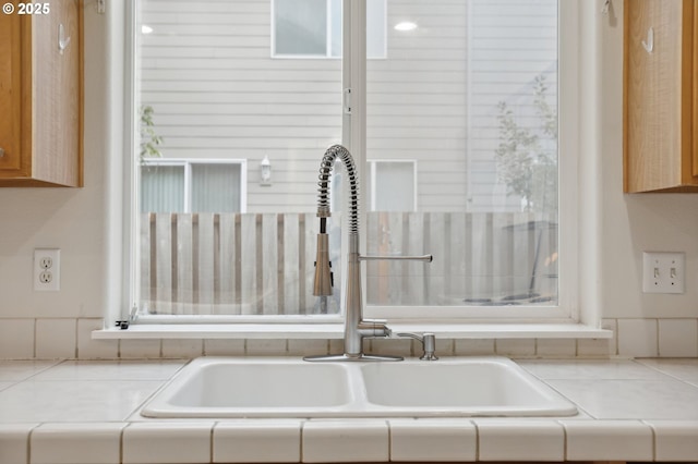 interior details with sink and tile countertops