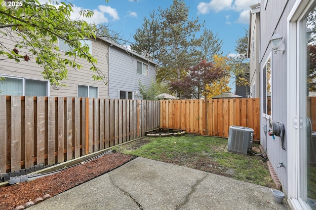 view of yard with cooling unit and a patio area