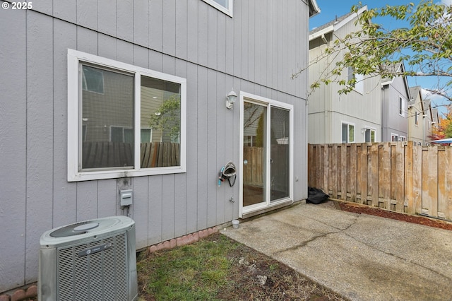 property entrance featuring a patio and central air condition unit