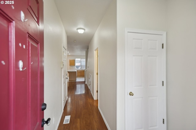 corridor with dark hardwood / wood-style floors