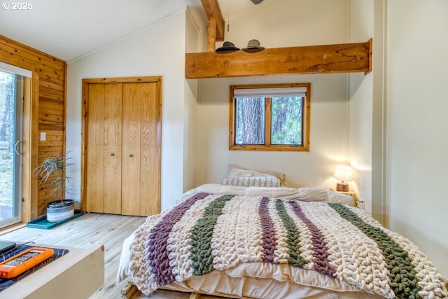 16811 Covina Rd, Bend, OR 97707 - bedroom featuring lofted ceiling, multiple windows, wood finished floors, wood walls, and a closet