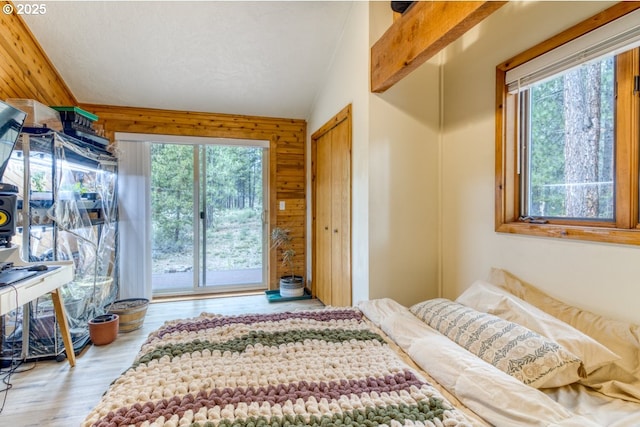 16811 Covina Rd, Bend, OR 97707 - bedroom featuring multiple windows, wood finished floors, access to exterior, and wooden walls