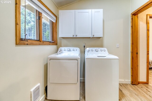 16811 Covina Rd, Bend, OR 97707 - laundry room featuring cabinet space, independent washer and dryer, and light wood finished floors