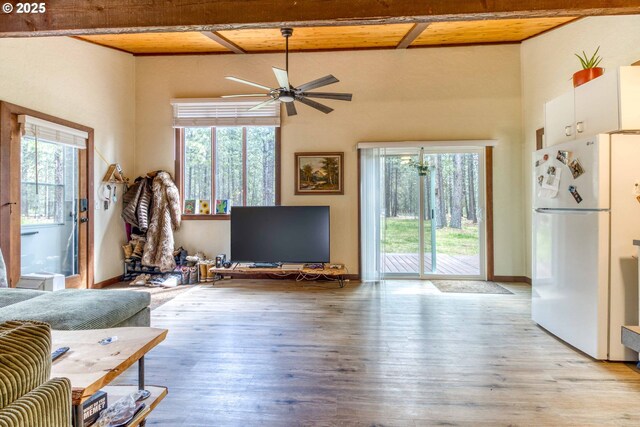 16811 Covina Rd, Bend, OR 97707 - living room with healthy amount of natural light, light wood-type flooring, a ceiling fan, and beam ceiling