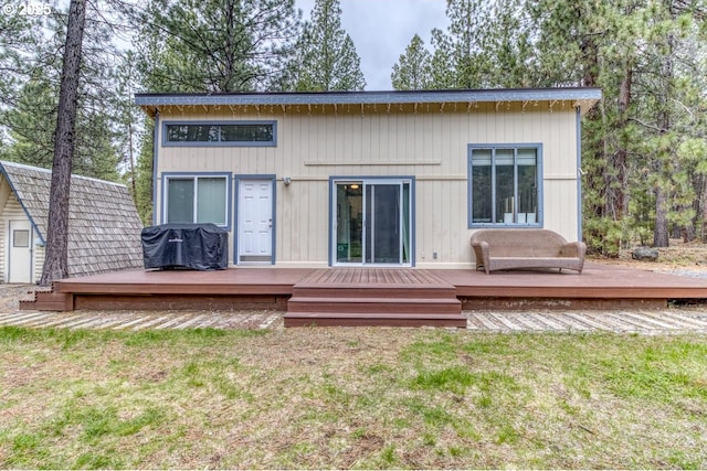 16811 Covina Rd, Bend, OR 97707 - rear view of house with a wooden deck, a lawn, and an outdoor structure