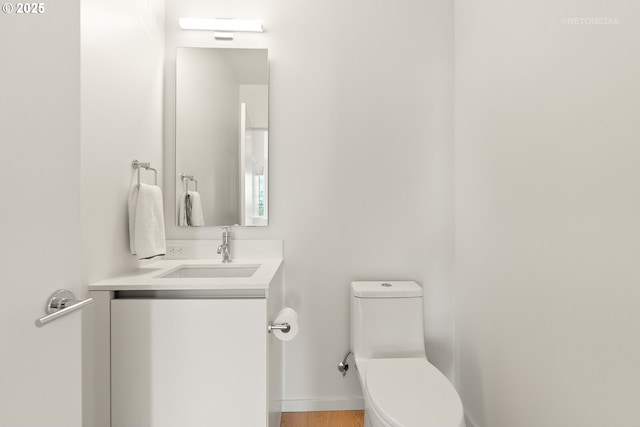 bathroom featuring toilet and vanity
