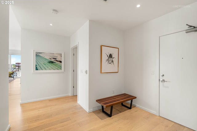 entryway with light wood-style floors, recessed lighting, and baseboards