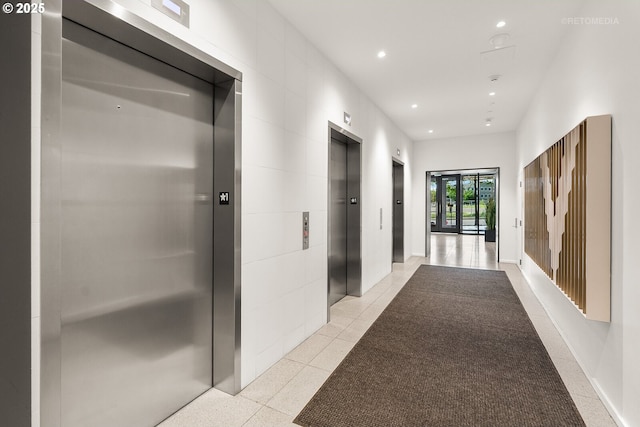 corridor with elevator and recessed lighting