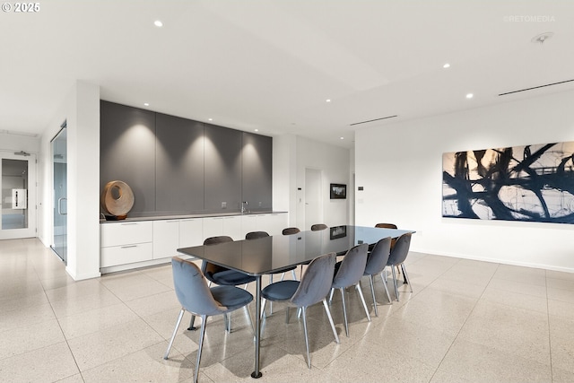 dining area with dark speckled floor, recessed lighting, and baseboards