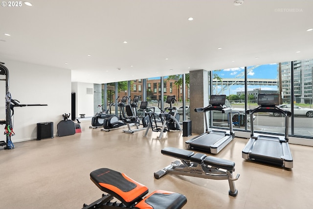 gym with floor to ceiling windows and recessed lighting
