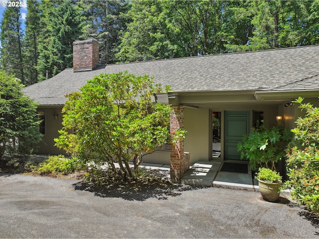 6151 SW Mill St, Portland, OR 97221 - view of front of property featuring a shingled roof and a chimney