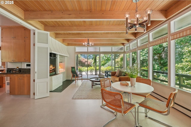 6151 SW Mill St, Portland, OR 97221 - sunroom featuring a chandelier, a wood ceiling with exposed beams, tile patterned floors, and a baseboard radiator