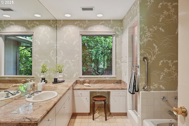 6151 SW Mill St, Portland, OR 97221 - bathroom with wallpapered walls, plenty of natural light, vanity, a garden tub, and tile patterned flooring