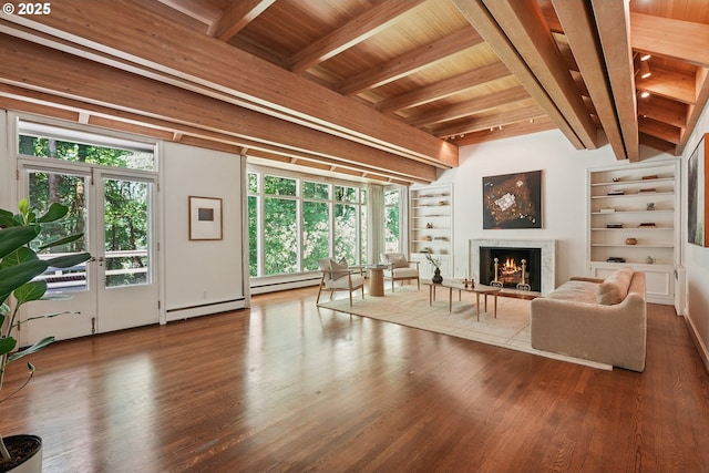 6151 SW Mill St, Portland, OR 97221 - living area with wood finished floors, built in features, a high end fireplace, a wood ceiling with exposed beams, and a baseboard radiator