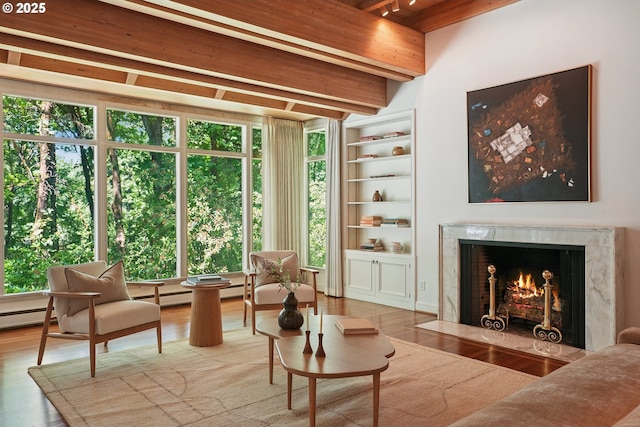 6151 SW Mill St, Portland, OR 97221 - living area with beamed ceiling, a high end fireplace, wood finished floors, and healthy amount of natural light