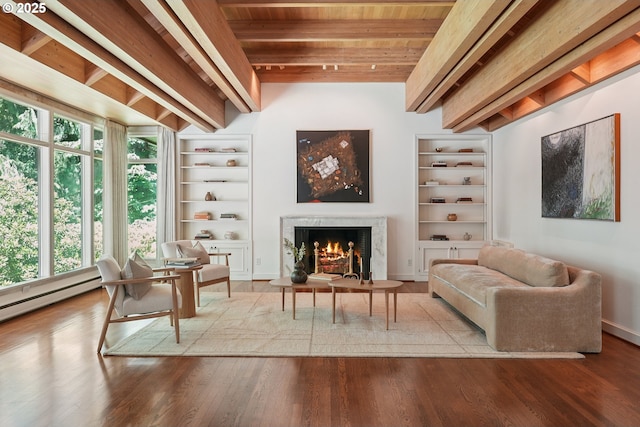 6151 SW Mill St, Portland, OR 97221 - living area with built in shelves, a wooden ceiling with exposed beams, a high end fireplace, and wood finished floors