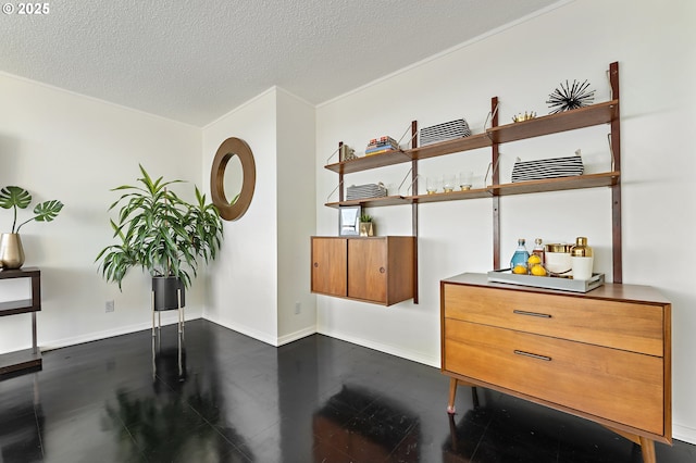 office space with a textured ceiling and baseboards