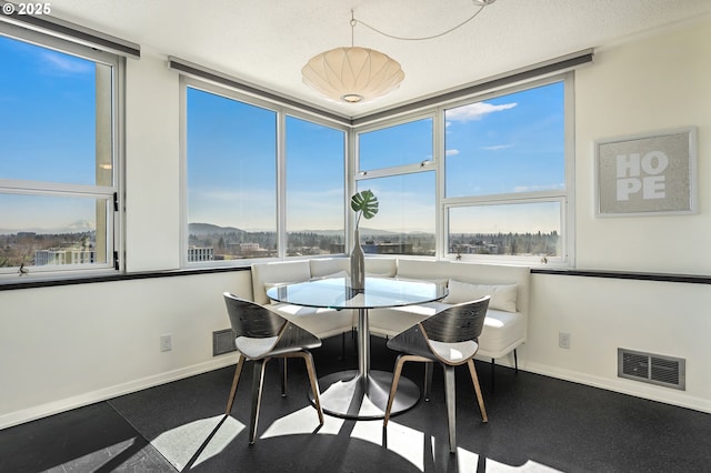 dining room featuring breakfast area, visible vents, and baseboards