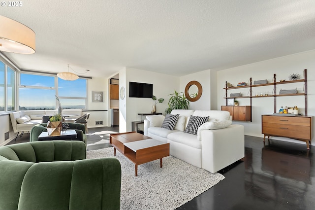 living room featuring finished concrete floors and a textured ceiling