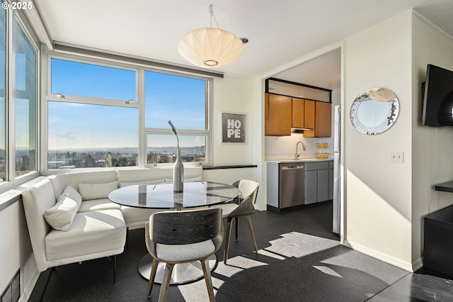 dining room featuring breakfast area and baseboards