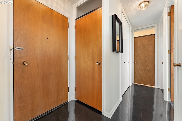 hall with a textured ceiling