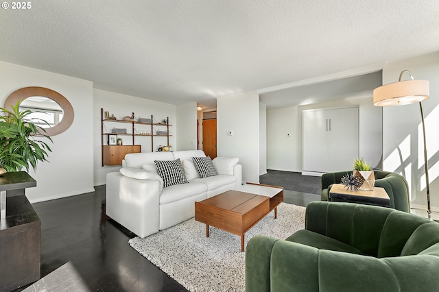 living area featuring baseboards and a textured ceiling