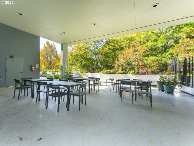 view of patio with fence and outdoor dining space