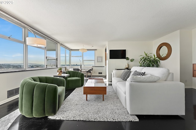 living room with visible vents, a textured ceiling, and baseboards