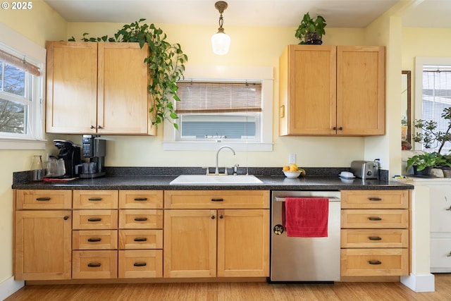 155 S 8th St, Saint Helens, OR 97051 - kitchen featuring dark countertops, stainless steel dishwasher, a sink, light wood finished floors, and light brown cabinets