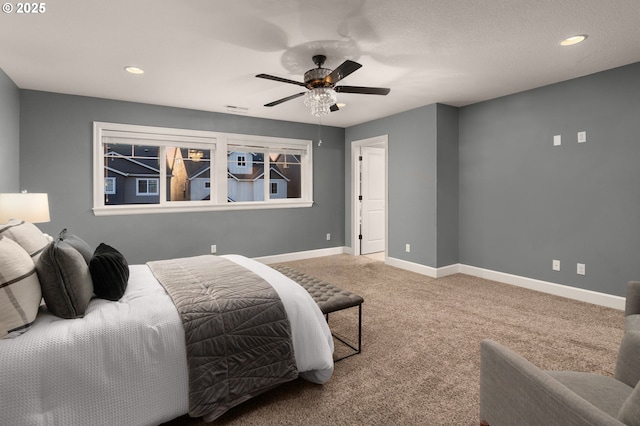 bedroom featuring ceiling fan and carpet