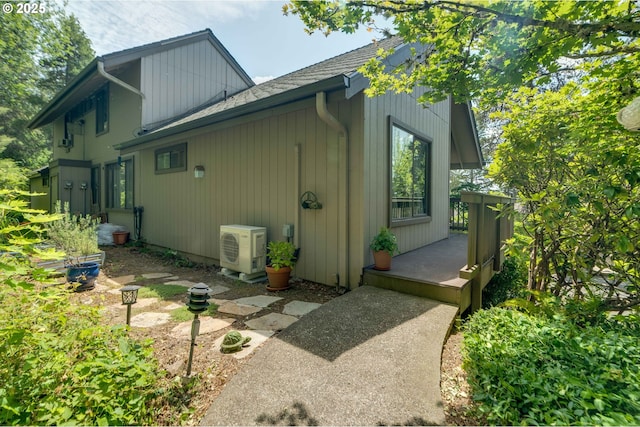 7508 SW Barnes Rd Unit A, Portland, OR 97225 - view of side of property featuring an ac unit and roof with shingles