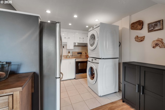 7508 SW Barnes Rd Unit A, Portland, OR 97225 - laundry room with stacked washing machine and dryer, light tile patterned floors, and recessed lighting